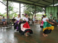 the girls doing a local dance, in local costumes