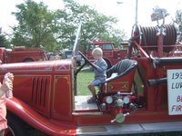 Koen checking out an old fire truck, he honked the horn and scared himself.