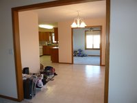 a view from the living room through the dining area to the kitchen and the four season porch