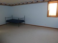 a large bedroom in the basement with a very large walk in closet