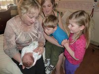 Grandma, Dinky, Keoni and Leilani check out the new baby