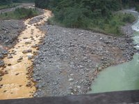 Two rivers come together under this bridge, one clean water, the other very yellow from sulfur in the rocks of the volcano where it originates.